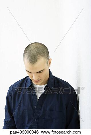 Stock Photograph - Young man with head down. Fotosearch