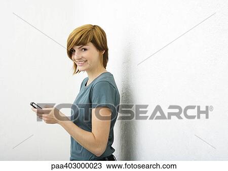 Young woman using cell phone View Large Photo Image Stock Image - Young woman using cell phone. Fotosearch