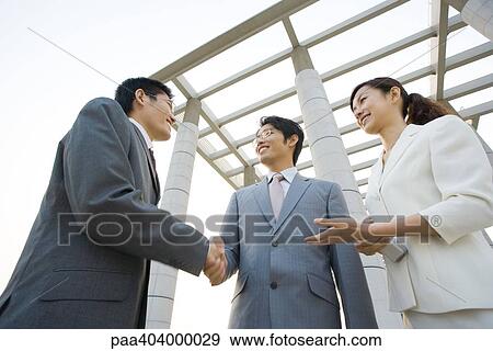 Business executives being introduced, low angle view View Large Photo Image Stock Photo - Business executives being introduced, low angle view. Fotosearch