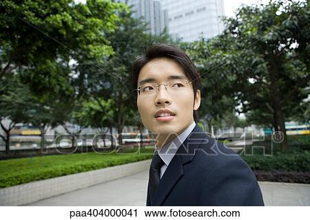 Businessman looking over shoulder View Large Photo Image Stock Image - Businessman looking over shoulder. Fotosearch
