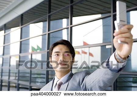 Businessman taking photo with cell phone View Large Photo Image Stock Photo - Businessman taking photo with cell phone. Fotosearch