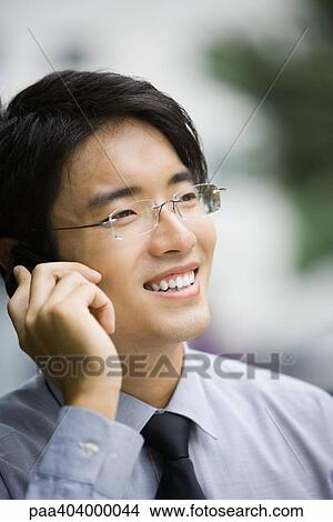 Businessman using cell phone, portrait View Large Photo Image Picture - Businessman using cell phone, portrait. Fotosearch