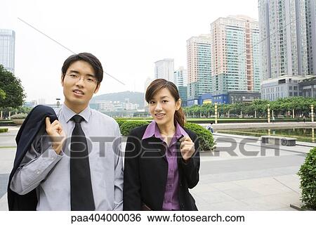 Two young business executives walking in office park View Large Photo Image Stock Photograph - Two young business executives walking in office park. Fotosearch
