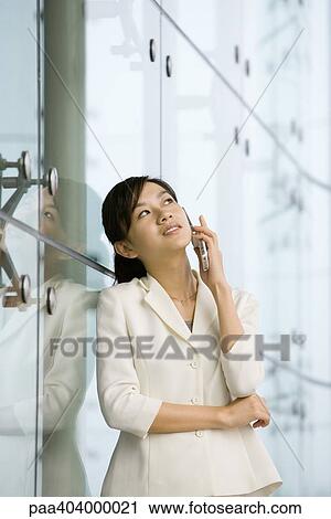 Young businesswoman using cell phone View Large Photo Image Stock Image - Young businesswoman using cell phone. Fotosearch