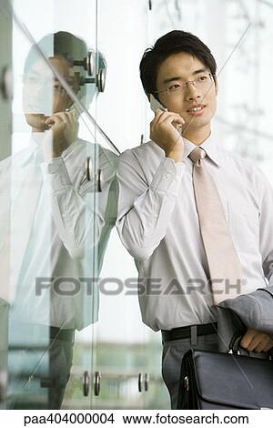 Young man using cell phone View Large Photo Image Picture - Young man using cell phone. Fotosearch