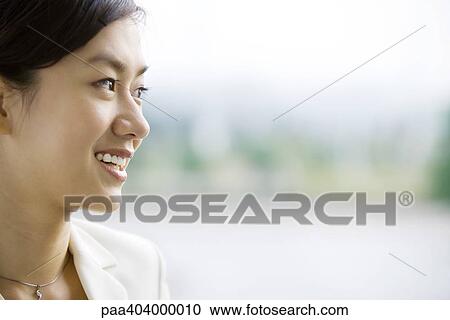 Young woman smiling, portrait View Large Photo Image Stock Image - Young woman smiling, portrait. Fotosearch