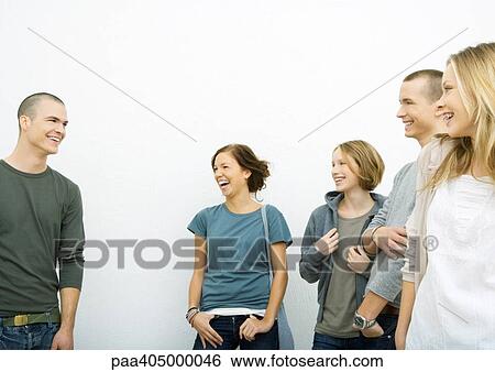 Group of young adults standing, laughing View Large Photo Image Stock Photograph - Group of young adults standing, laughing. Fotosearch
