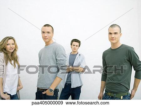 Group of young adults standing with hands in pockets View Large Photo Image Stock Photo - Group of young adults standing with hands in pockets. Fotosearch