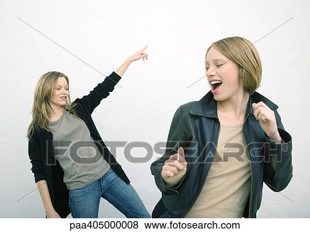 Stock Photo - Two female friends dancing. Fotosearch