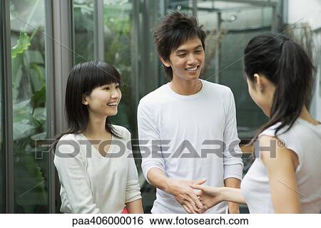 Young adults shaking hands View Large Photo Image Stock Photograph - Young adults shaking hands. Fotosearch