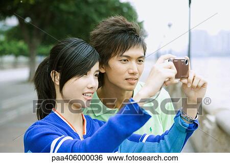 Young couple, taking photo with digital camera View Large Photo Image Stock Photograph - Young couple, taking photo with digital camera. Fotosearch