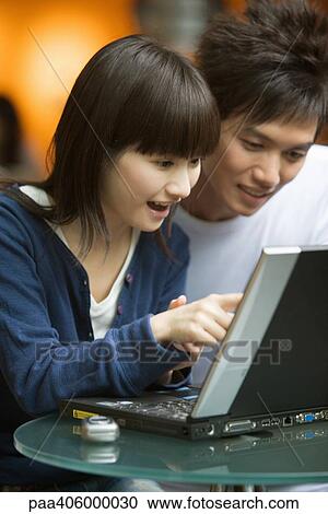 Young couple using laptop View Large Photo Image Stock Image - Young couple using laptop. Fotosearch