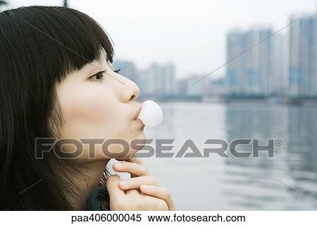 Young woman blowing bubble View Large Photo Image Stock Photography - Young woman blowing bubble. Fotosearch