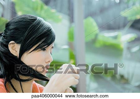 Young woman looking at hair View Large Photo Image Picture - Young woman looking at hair. Fotosearch