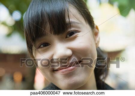 Stock Photo - Young woman smiling, portrait. Fotosearch