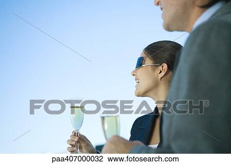 Business colleagues holding glasses of champagne View Large Photo Image Stock Image - Business colleagues holding glasses of champagne. Fotosearch