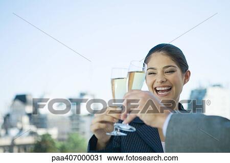 Business colleagues toasting with glasses of champagne, laughing View Large Photo Image Stock Image - Business colleagues toasting with glasses of champagne, laughing. Fotosearch