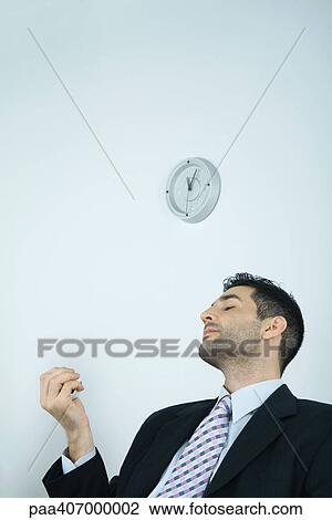 Businessman holding stress ball, eyes closed View Large Photo Image Stock Image - Businessman holding stress ball, eyes closed. Fotosearch