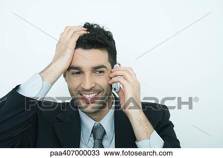 Businessman using cell phone, holding head View Large Photo Image Stock Image - Businessman using cell phone, holding head. Fotosearch