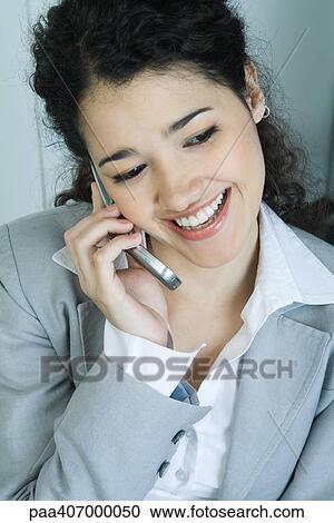 Stock Image - Businesswoman using cell phone, portrait. Fotosearch
