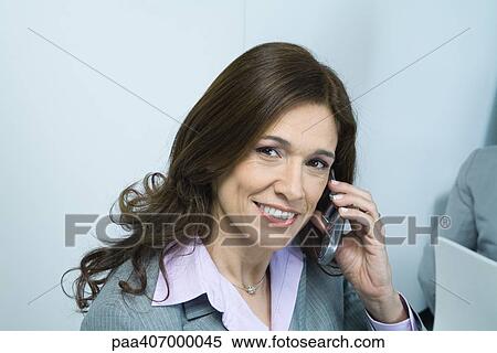 Stock Photography - Businesswoman using cell phone. Fotosearch