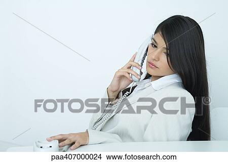 Businesswoman using phone View Large Photo Image Picture - Businesswoman using phone. Fotosearch