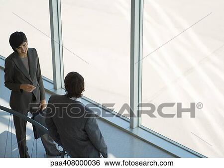 Business associates talking, high angle view View Large Photo Image Stock Photograph - Business associates talking, high angle view. Fotosearch