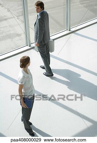Man and woman looking over shoulders at each other, full length, high angle view View Large Photo Image Stock Photo - Man and woman looking over shoulders at each other, full length, high angle view. Fotosearch