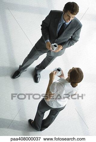 Office employees standing with coffee cups, full length, high angle view View Large Photo Image Stock Photo - Office employees standing with coffee cups, full length, high angle view. Fotosearch