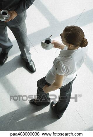 Office employees standing with coffee cups, high angle view View Large Photo Image Stock Photo - Office employees standing with coffee cups, high angle view. Fotosearch