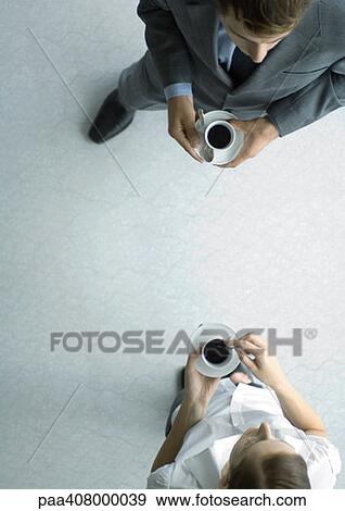 Office employees standing with coffee cups, view from directly above View Large Photo Image Stock Photo - Office employees standing with coffee cups, view from directly above. Fotosearch