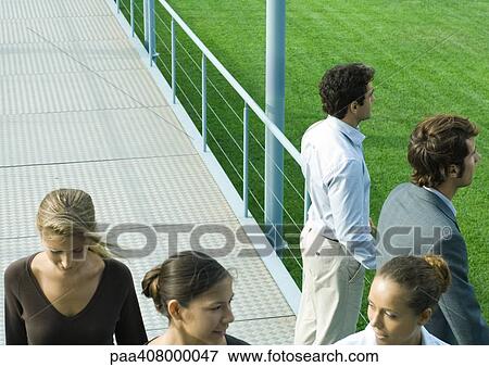 Stock Photo - People standing and walking on walkway. Fotosearch
