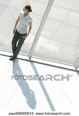 Woman standing by window, full length, high angle view View Large Photo Image Stock Photography - Woman standing by window, full length, high angle view. Fotosearch