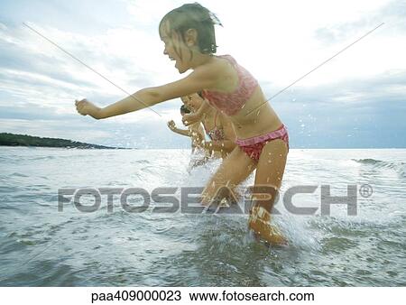 Children playing in surf View Large Photo Image Stock Image - Children playing in surf. Fotosearch