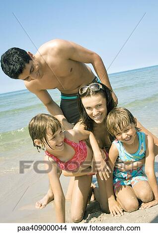 Picture - Family on beach, smiling. Fotosearch
