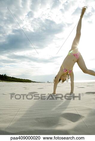 Girl doing cartwheel on beach View Large Photo Image Stock Image - Girl doing cartwheel on beach. Fotosearch