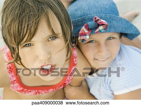 Stock Photo - Two girls on beach, close-up portrait. Fotosearch