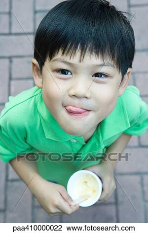 Boy eating ice cream, licking lips View Large Photo Image Stock Image - Boy eating ice cream, licking lips. Fotosearch