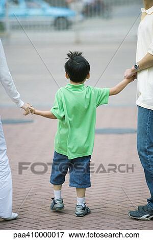 Boy holding parents' hands View Large Photo Image Stock Photo - Boy holding parents' hands. Fotosearch