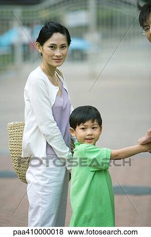 Boy holding parents' hands View Large Photo Image Stock Photo - Boy holding parents' hands. Fotosearch