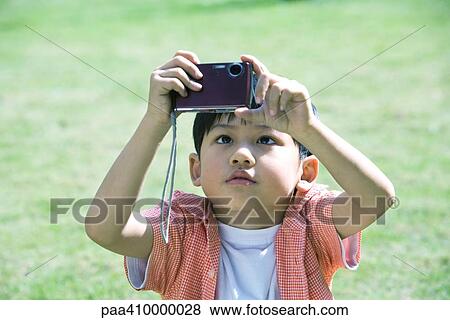 Boy using digital camera View Large Photo Image Stock Photo - Boy using digital camera. Fotosearch