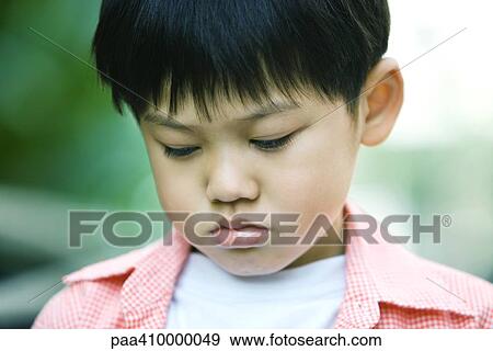 Boy with eyes lowered, portrait View Large Photo Image Stock Photo - Boy with eyes lowered, portrait. Fotosearch