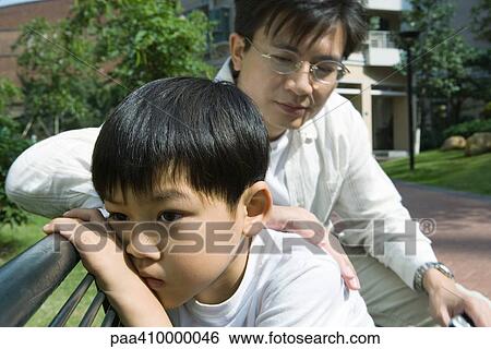 Father and son on bench, boy pouting View Large Photo Image Stock Photograph - Father and son on bench, boy pouting. Fotosearch