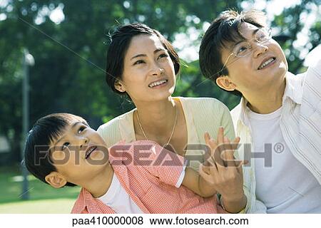 Man, woman and son, looking up View Large Photo Image Stock Photo - Man, woman and son, looking up. Fotosearch