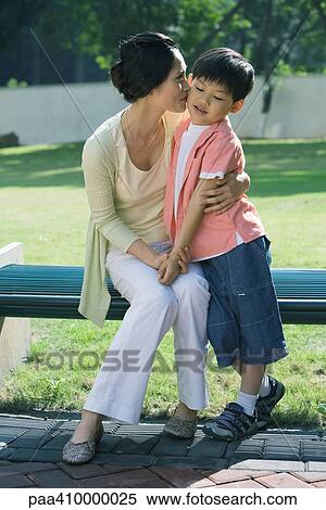 Mother kissing son on cheek View Large Photo Image Stock Photography - Mother kissing son on cheek. Fotosearch