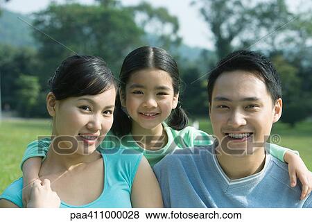 Girl and parents, smiling at camera, portrait View Large Photo Image Stock Photo - Girl and parents, smiling at camera, portrait. Fotosearch