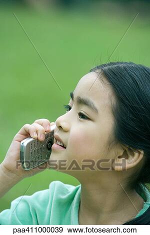 Girl using cell phone, close-up View Large Photo Image Stock Photo - Girl using cell phone, close-up. Fotosearch