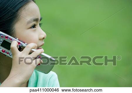 Girl using cell phone, side view, close-up View Large Photo Image Stock Photograph - Girl using cell phone, side view, close-up. Fotosearch