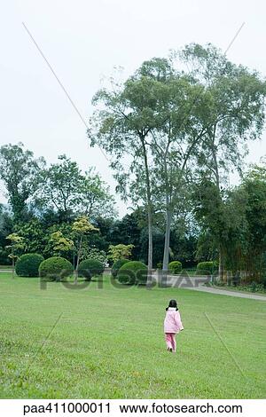 Girl walking across grass, rear view View Large Photo Image Stock Image - Girl walking across grass, rear view. Fotosearch