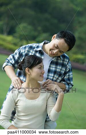 Man massaging woman's shoulders View Large Photo Image Picture - Man massaging woman's shoulders. Fotosearch